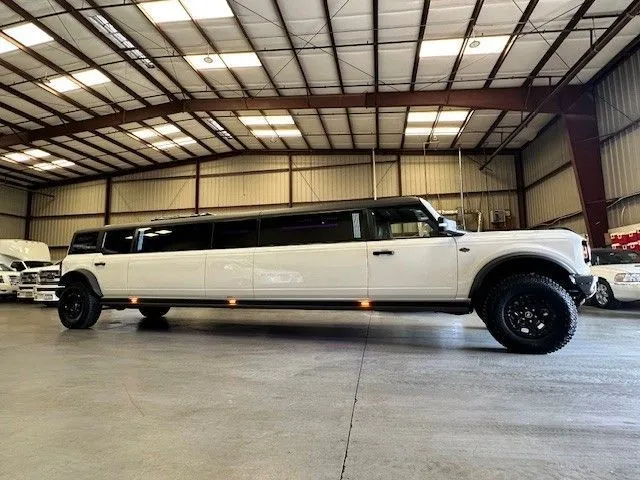 13 Passenger Bronco Limousine with Jet Door for party bus rental for booking