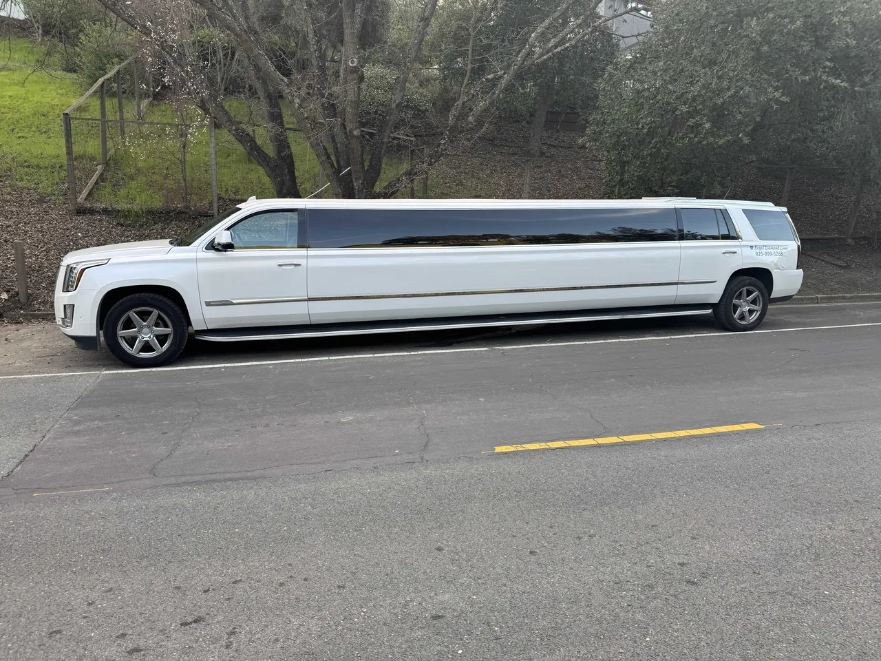 Cadillac Escalade Limousine (white) for party bus rental: full view, with tinted windows