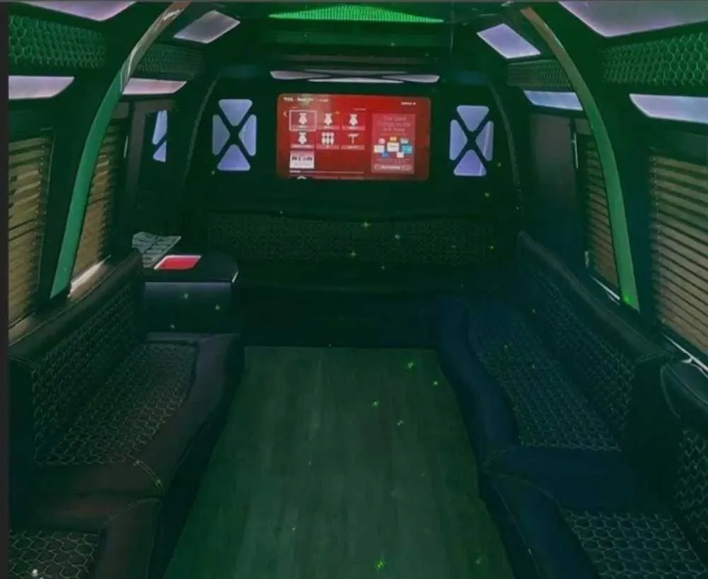 D-Town Bus for party bus rental: seating area, with perimeter lounge seating, window shades and LED accent lighting