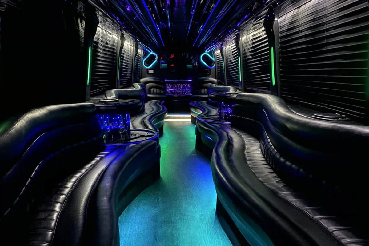 Entertainment Coach for party bus rental: seating area, with perimeter lounge seating, window shades and LED accent lighting