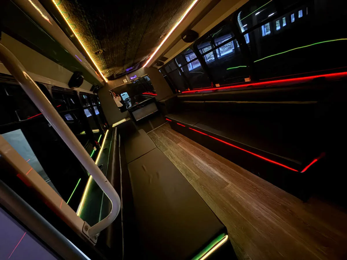 Ford E-450 Series Party Bus: seating area, with perimeter lounge seating, LED accent lighting and LED ceiling lighting