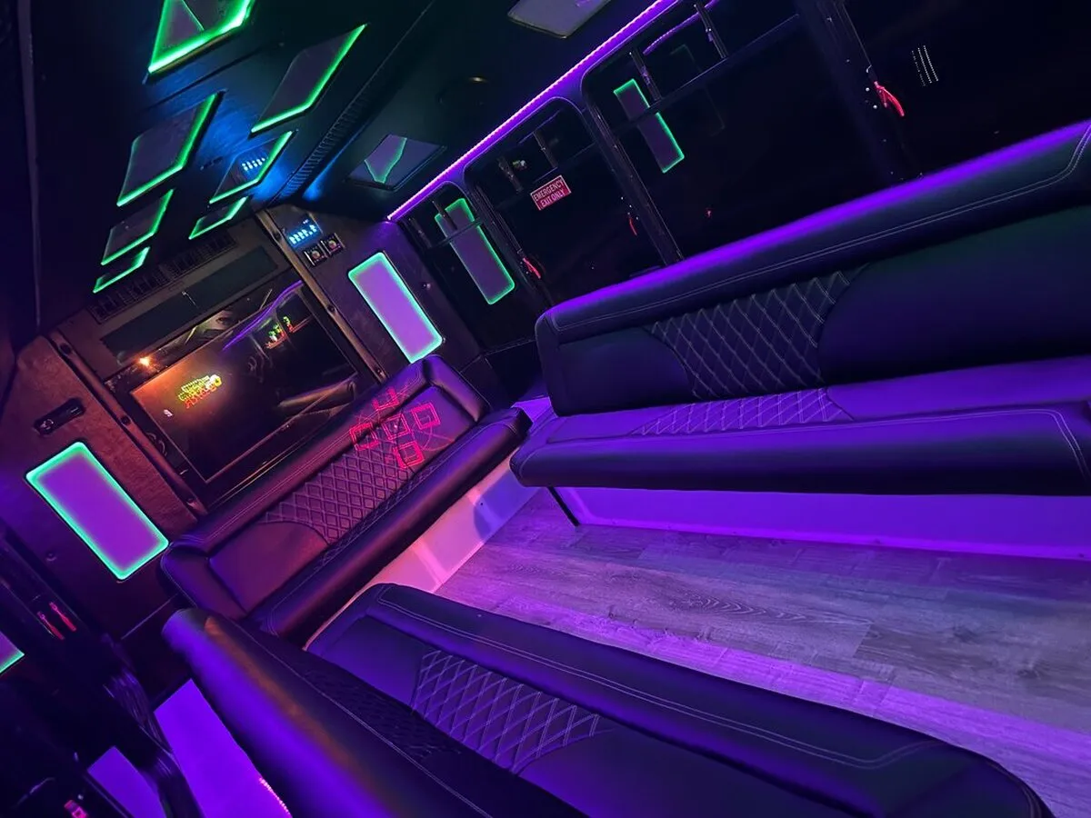 Ford E-450 Series Party Bus: seating area, with perimeter lounge seating, LED accent lighting and LED ceiling lighting