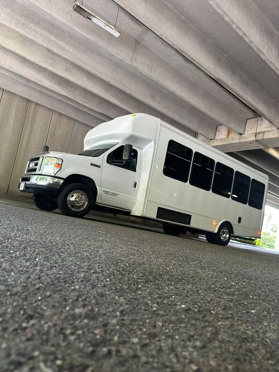Ford E-450 Series Party Bus (white): full view, with tinted windows
