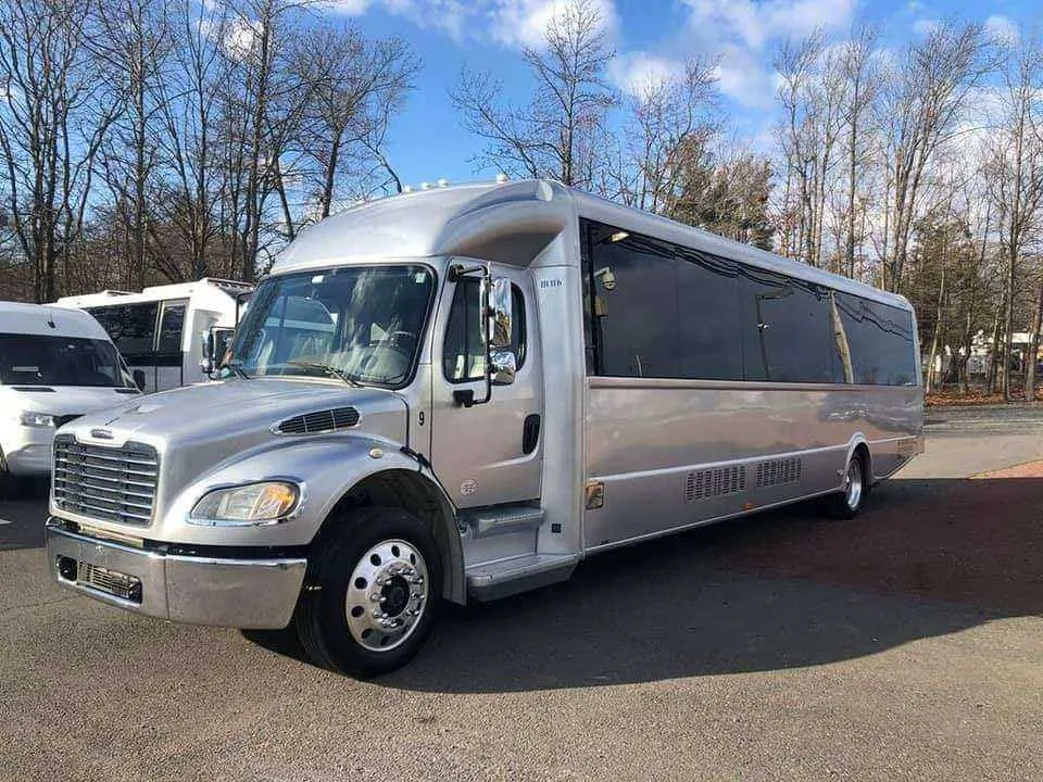 Limousine Bus (silver) for party bus rental, with tinted windows