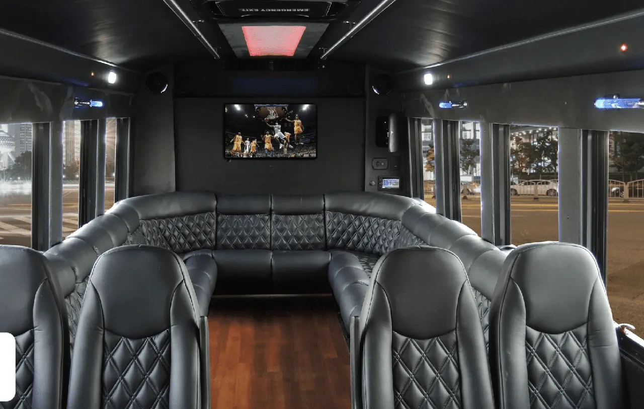 Limousine Coach for party bus rental: seating area, with perimeter lounge seating, sofa-style seating and wood-look flooring