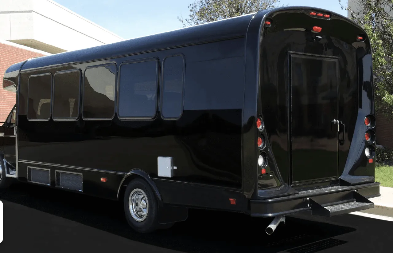 Limousine Coach (black) for party bus rental: full view, with tinted windows