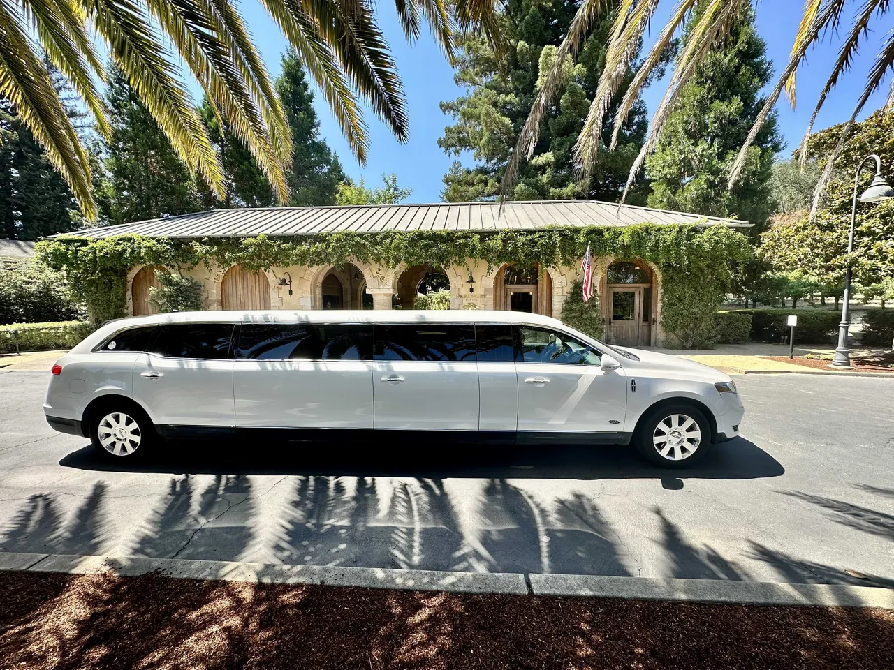 Lincoln MKT Limousine (white) for party bus rental for booking