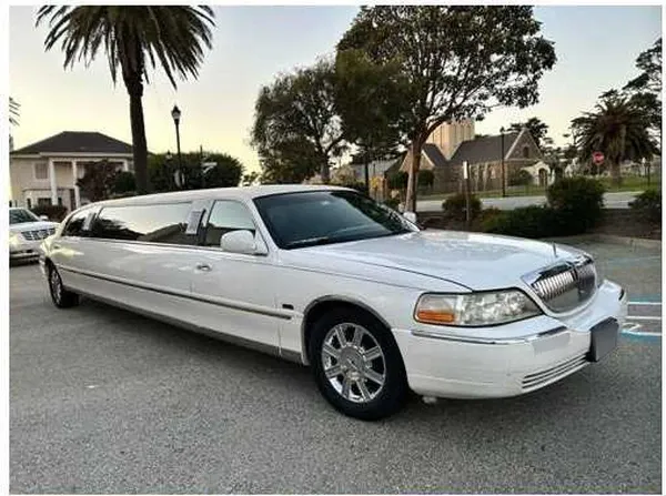 Lincoln Town Car Limousine (white) for party bus rental for booking