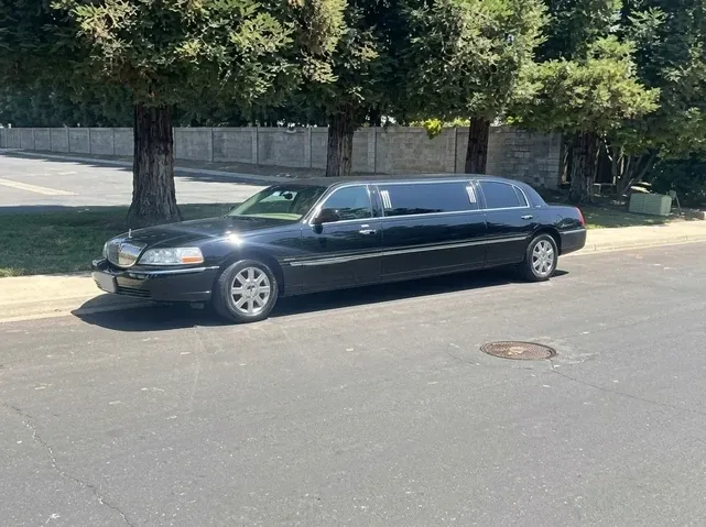 Lincoln Town Car Limousine (black) for party bus rental for booking