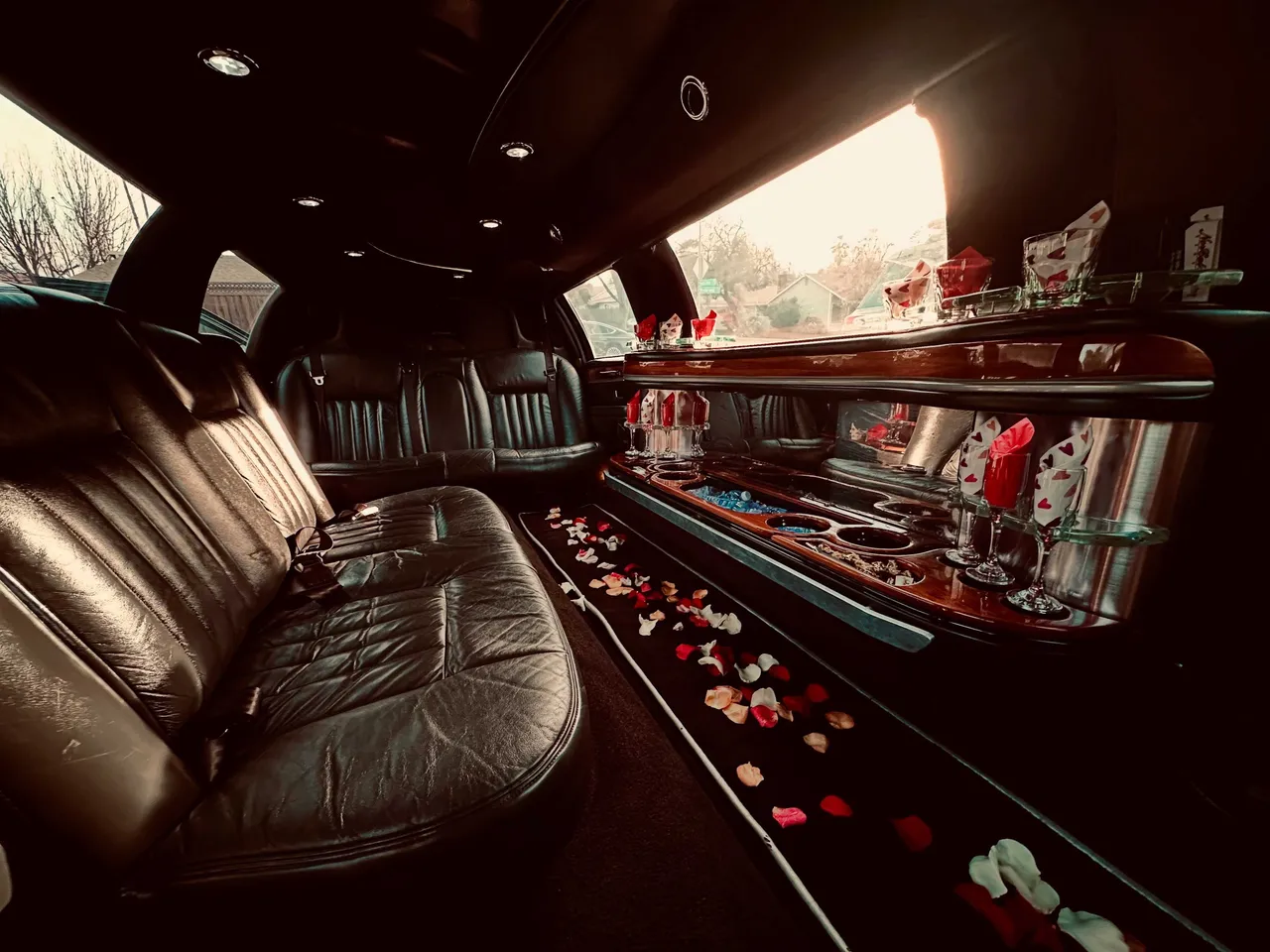Lincoln Town Car Limousine for party bus rental: seating area, with perimeter lounge seating, cup holders and bar area Lincoln Town Car Limousine for party bus rental: seating area, with perimeter lounge seating, cup holders and bar area