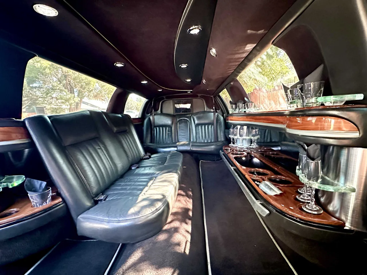 Lincoln Town Car Limousine for party bus rental: seating area, with perimeter lounge seating, cup holders and bar area, pic 4 Lincoln Town Car Limousine for party bus rental: seating area, with perimeter lounge seating, cup holders and bar area, pic 4