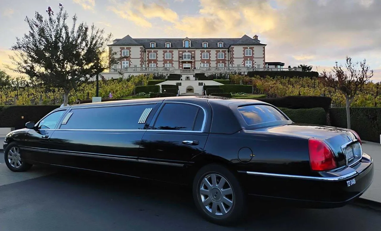 Lincoln Town Car Stretch Limousine (black) for party bus rental, with tinted windows