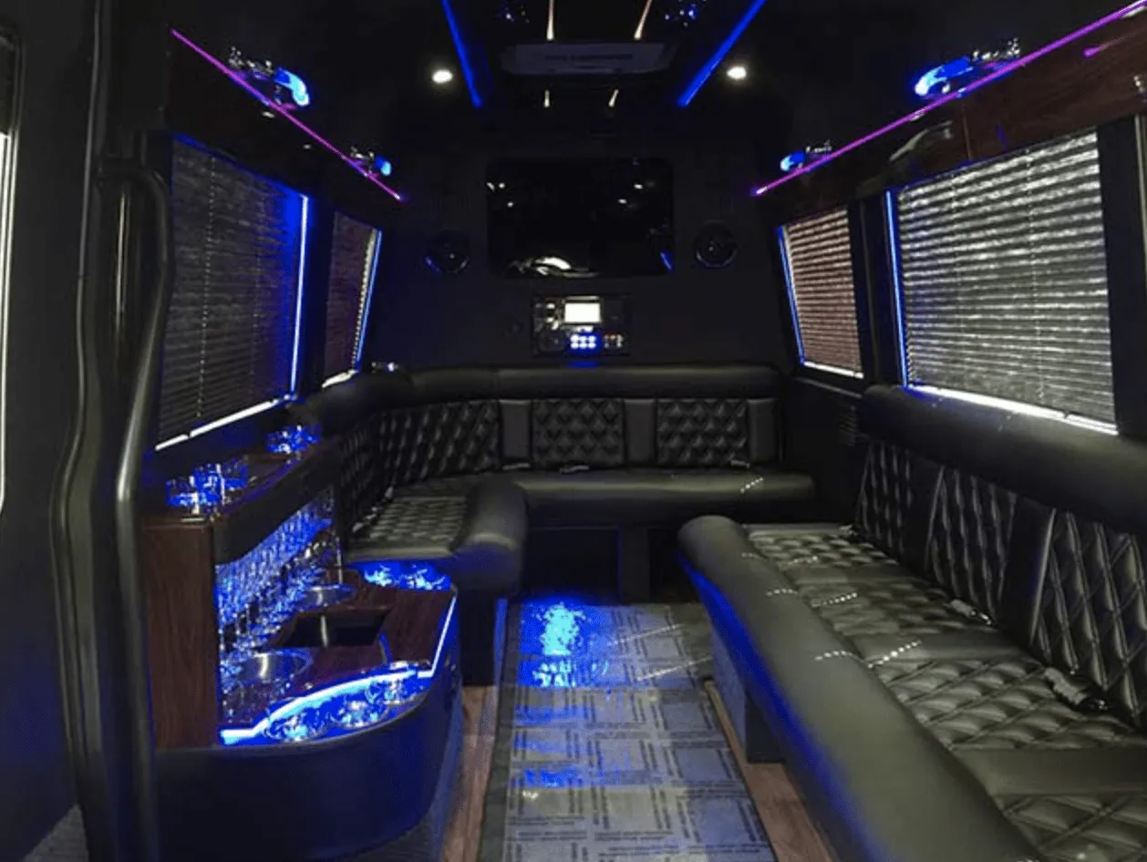 Mercedes-Benz Limousine Sprinter for party bus rental: seating area, with perimeter lounge seating, window shades and LED accent lighting