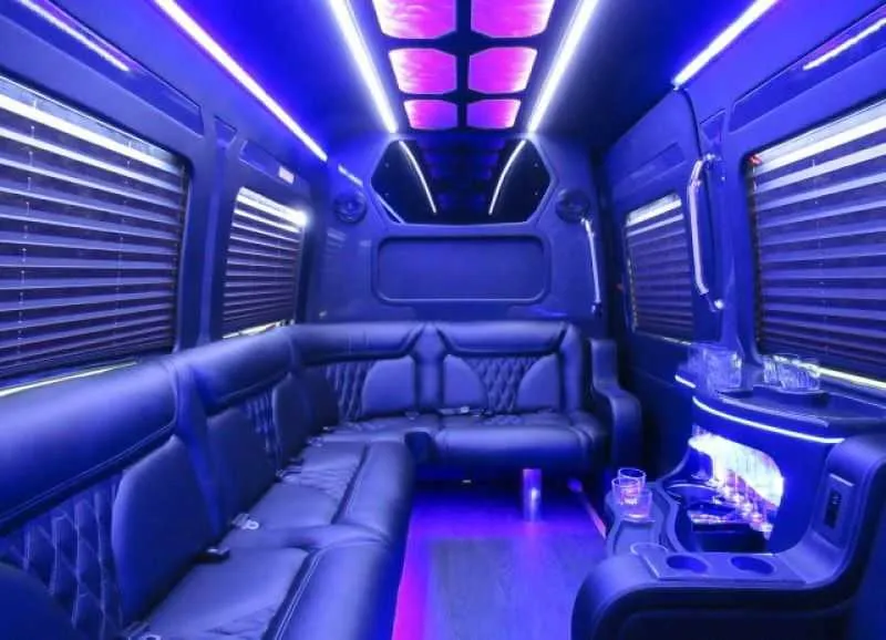 Mercedes-Benz Limousine Sprinter for party bus rental: seating area, with perimeter lounge seating, window shades and LED accent lighting