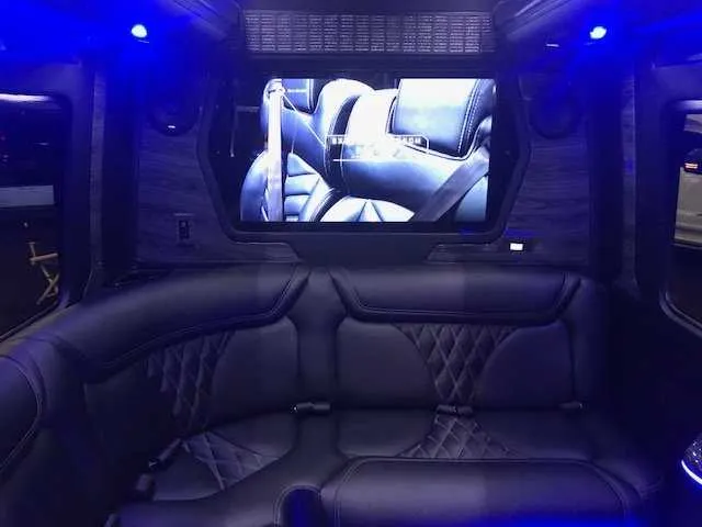 Mercedes-Benz Party Bus: seating area, with sofa-style seating, LED accent lighting and TV screens