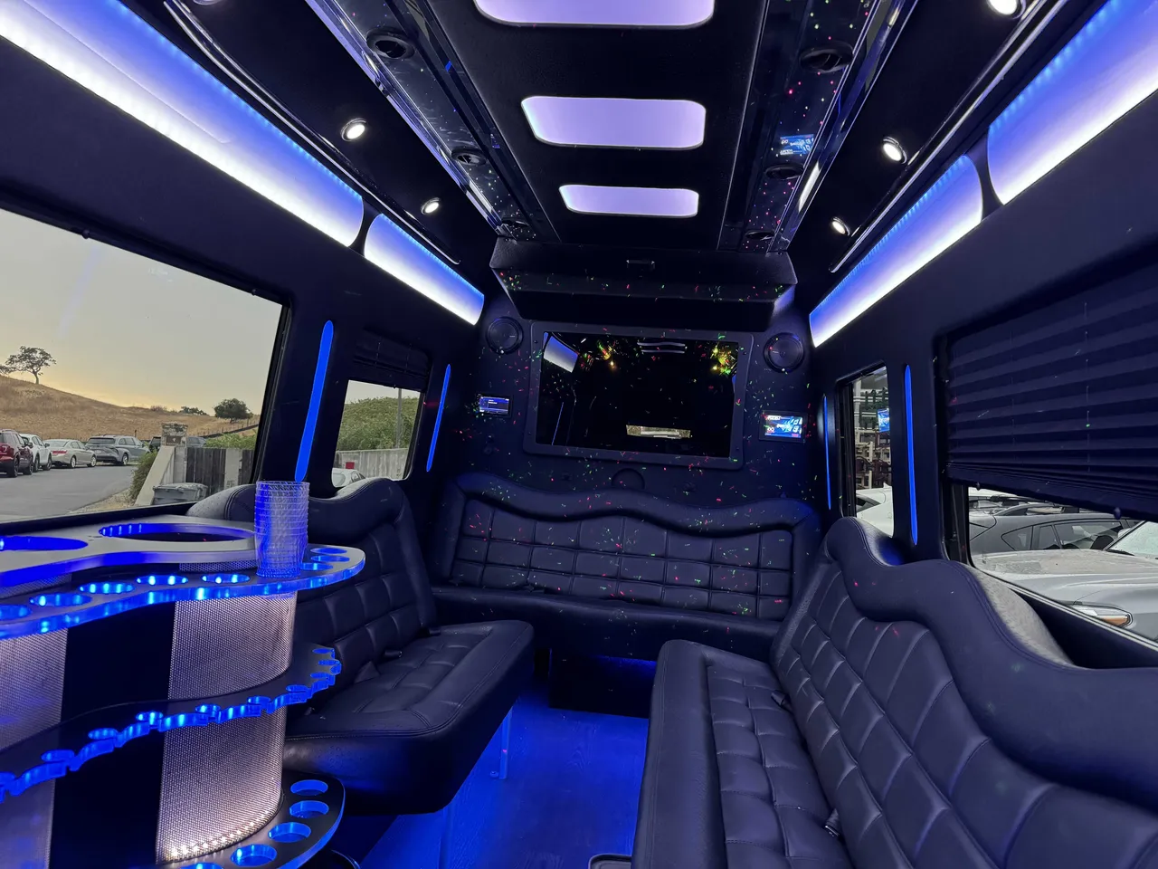 Mercedes-Benz Party Bus: seating area, with perimeter lounge seating, window shades and LED accent lighting