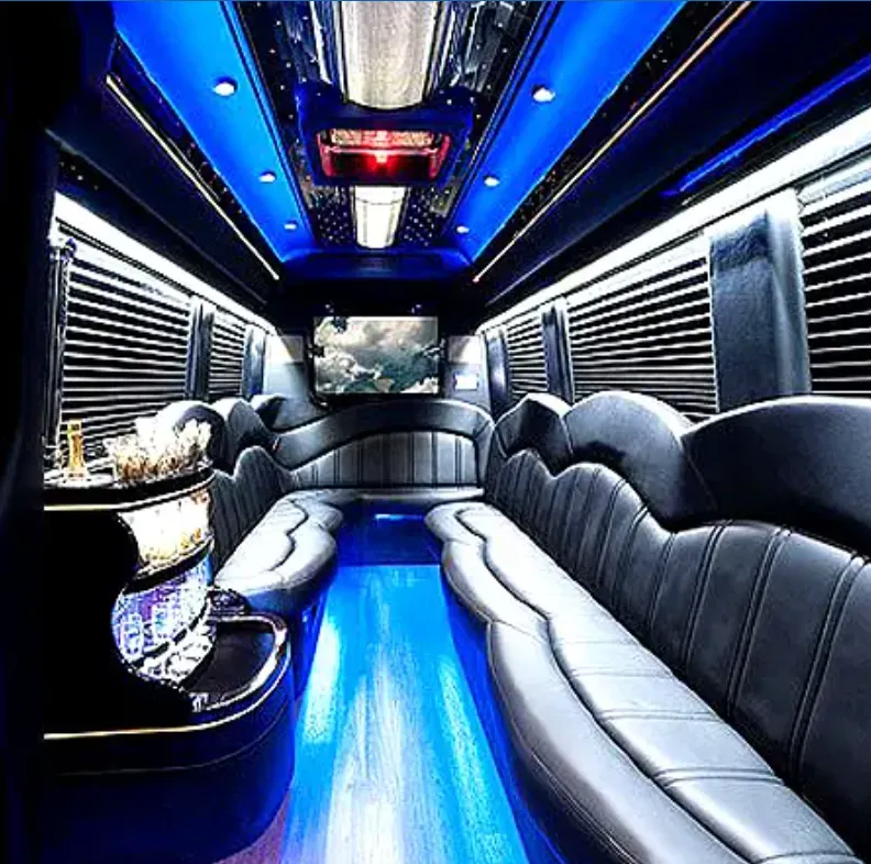 Mercedes-Benz Sprinter Limousine for party bus rental: seating area, with perimeter lounge seating, sofa-style seating and window shades