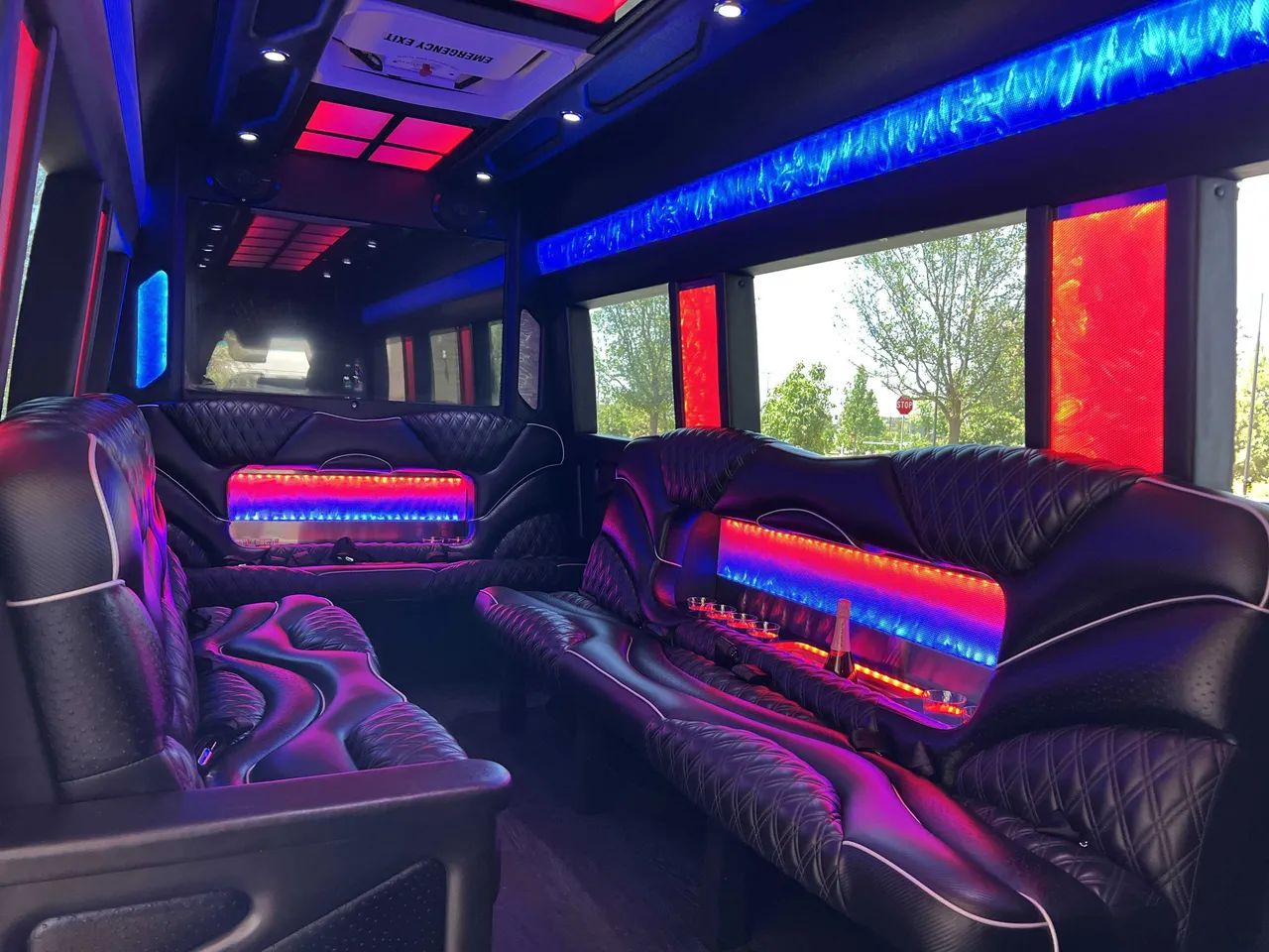 Mercedes-Benz Sprinter Limousine for party bus rental: seating area, with sofa-style seating, LED accent lighting and LED ceiling lighting, pic 3