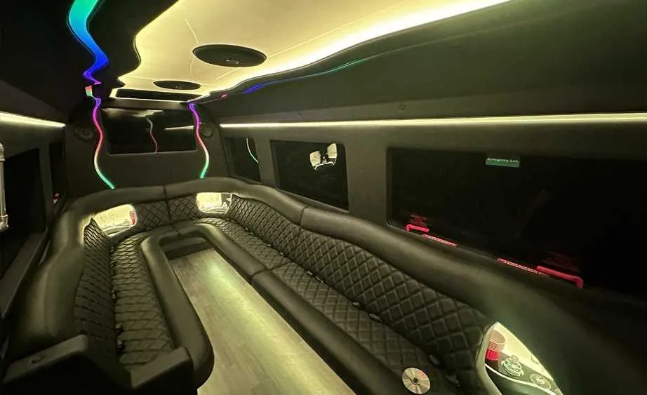 Mercedes-Benz Sprinter Limousine for party bus rental: seating area, with perimeter lounge seating, LED accent lighting and bar area