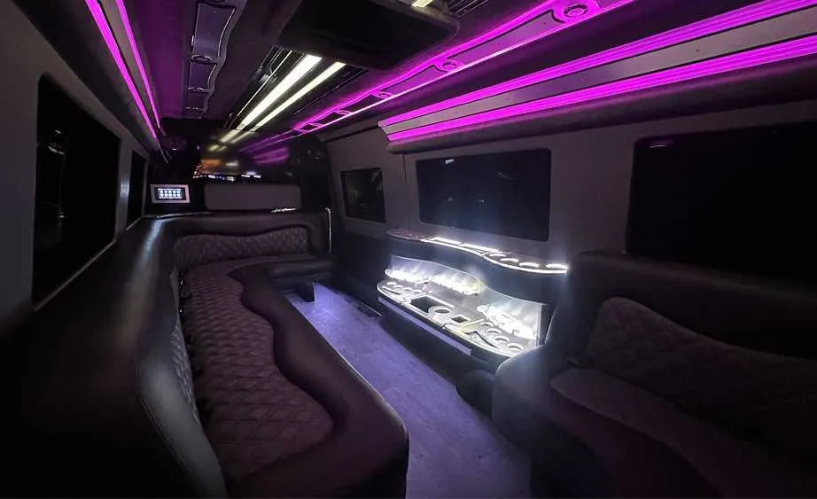 Mercedes-Benz Sprinter Limousine for party bus rental: seating area, with perimeter lounge seating, LED accent lighting and bar area, pic 5