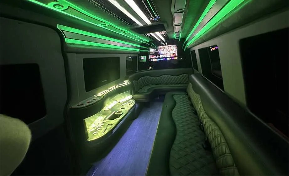 Mercedes-Benz Sprinter Limousine for party bus rental: seating area, with perimeter lounge seating, LED accent lighting and bar area, pic 3