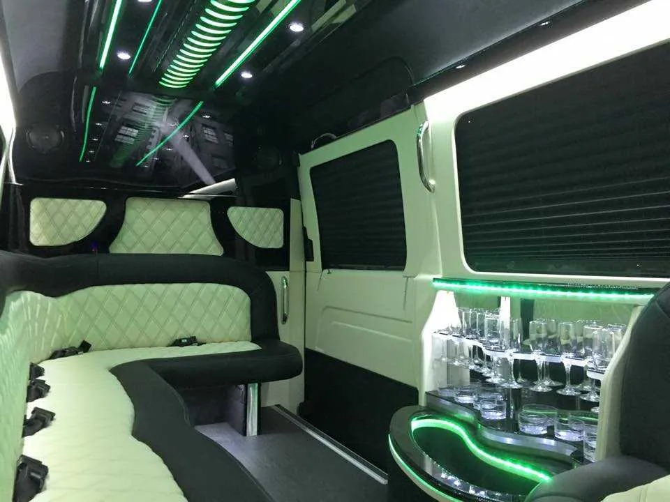 Mercedes-Benz Sprinter Limousine for party bus rental: seating area, with perimeter lounge seating, sofa-style seating and window shades, pic 2