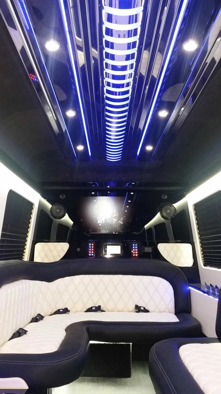 Mercedes-Benz Sprinter Limousine for party bus rental: seating area, with perimeter lounge seating, sofa-style seating and window shades, pic 3
