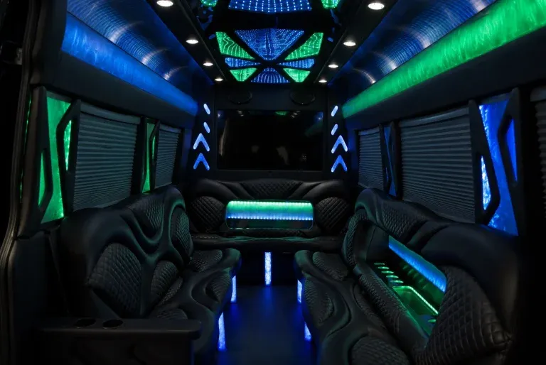 Mercedes-Benz Sprinter Limousine for party bus rental: seating area, with perimeter lounge seating, window shades and LED accent lighting