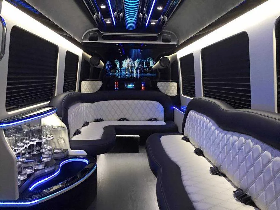 Mercedes-Benz Sprinter Limousine for party bus rental: seating area, with perimeter lounge seating, sofa-style seating and window shades