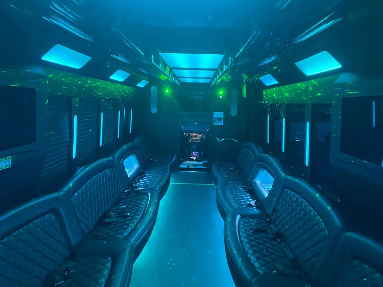25 Passenger Party Bus: seating area, with perimeter lounge seating, LED accent lighting and LED ceiling lighting