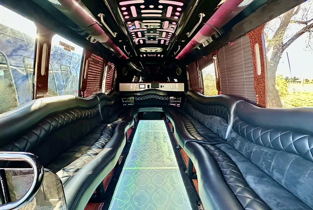 20 Passenger Party Bus: seating area, with perimeter lounge seating, window shades and LED ceiling lighting