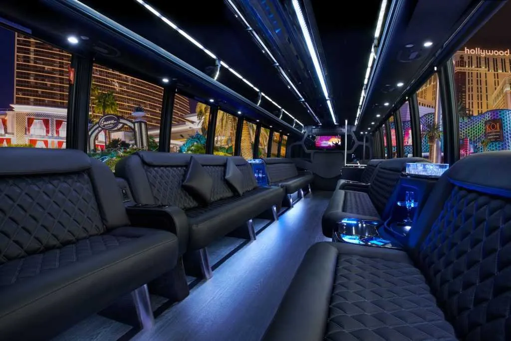 Black 30 Passenger Party Bus 30 Passenger Party Bus: seating area, with perimeter lounge seating, LED accent lighting and LED ceiling lighting