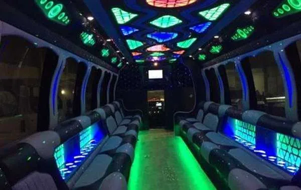 Party Bus Black: seating area, with perimeter lounge seating, LED accent lighting and LED ceiling lighting
