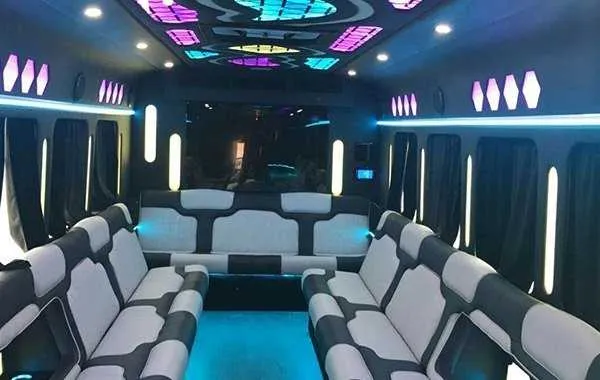 Party Bus White Party Bus White: seating area, with perimeter lounge seating, window shades and LED accent lighting