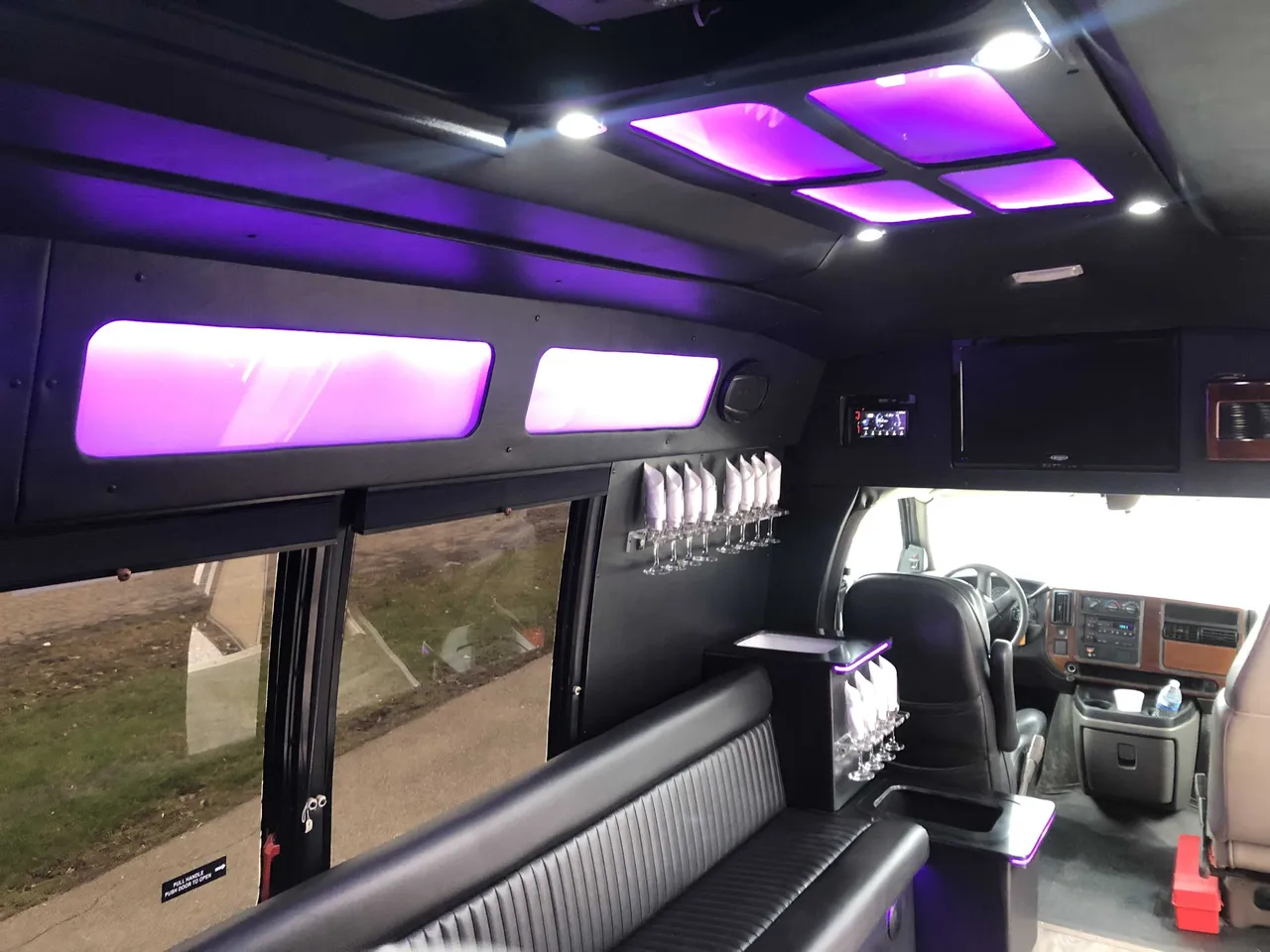 Small Party Bus Small Party Bus: seating area, with perimeter lounge seating, LED ceiling lighting and glassware holders