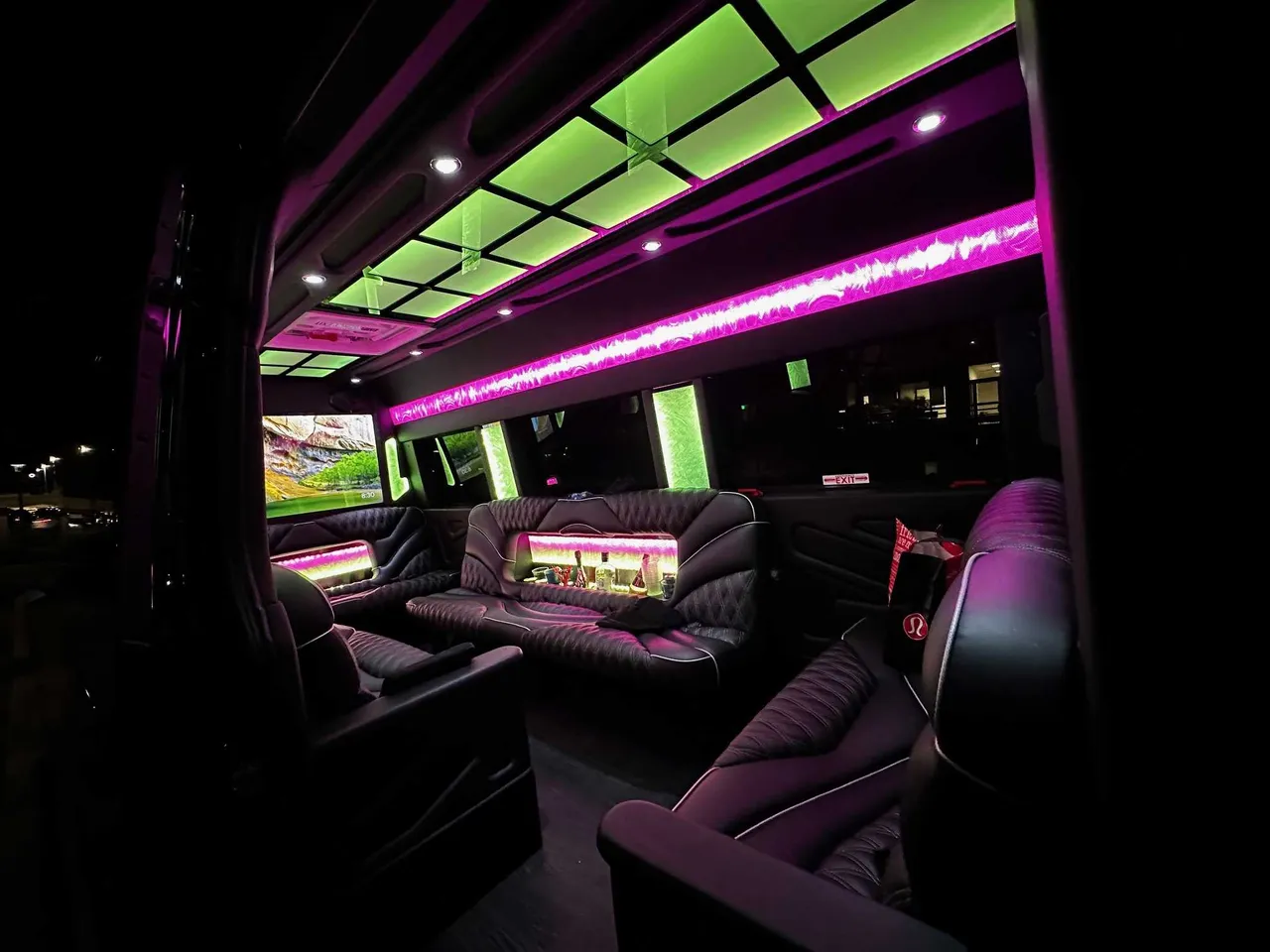 13 Passenger Sprinter Limousine 13 Passenger Sprinter Limousine for party bus rental: seating area, with sofa-style seating, captain's chairs and LED accent lighting