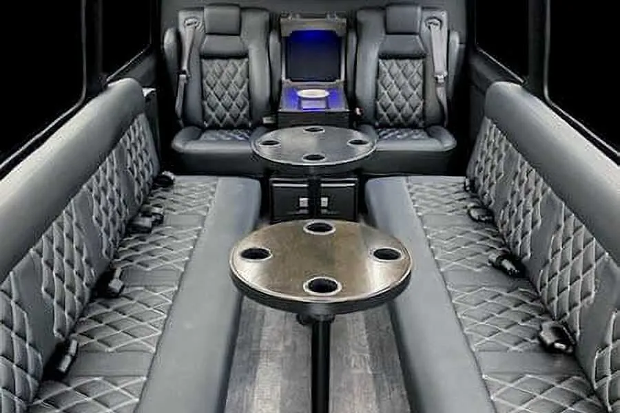 12 Passenger Sprinter Van 12 Passenger Sprinter Van for party bus rental: seating area, with perimeter lounge seating, captain's chairs and passenger tables