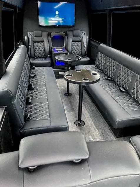 12 Passenger Sprinter Van for party bus rental: seating area, with perimeter lounge seating, captain's chairs and passenger tables, pic 2