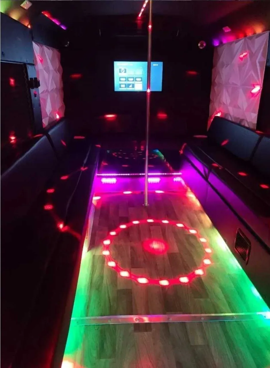 Tuxedo Party Bus: seating area, with perimeter lounge seating, LED accent lighting and lit dance floor