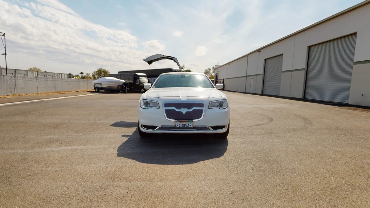 White Chrysler 300 Stretch Limousine for party bus rental for booking